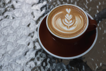 Hot coffee latte with beautiful latte art  on ceramic glass in local indy coffee cafe at Thailand.