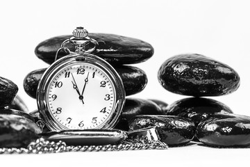 High Contrast Image of a Pocket Watch and stacked stones