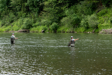 Fly fisherman flyfishing in river
