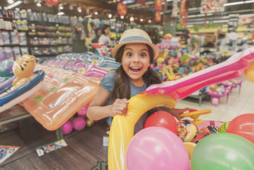 Hilarious laughing small girl in store