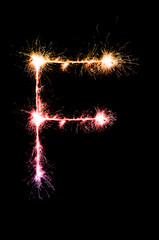 English alphabet from sparkler on black background,Alphabet big letter