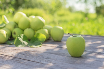 green apples on wooden background outdoor