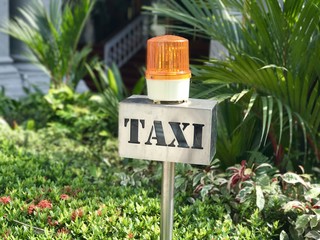 Metal Taxi stand sign with orange rotating light
