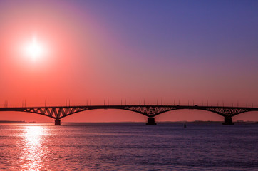 Sunrise over a road bridge across the Volga river between the cities of Saratov and Engels, Russia.