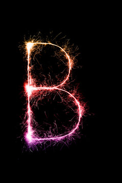 English alphabet from sparkler on black background,Alphabet big letter