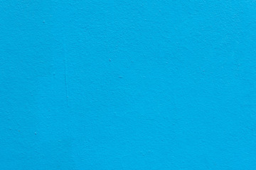 Background of Cement wall painted bright blue and rough.