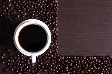 cup of hot coffee on coffee beans background