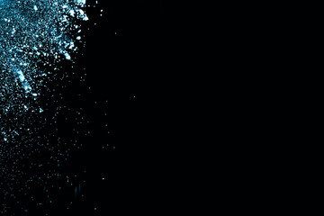 Abstract blue powder splatted on white background. Freeze motion of blue powder exploding on blackbackgrund.