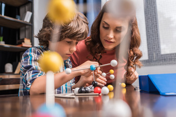 family playing with atoms model