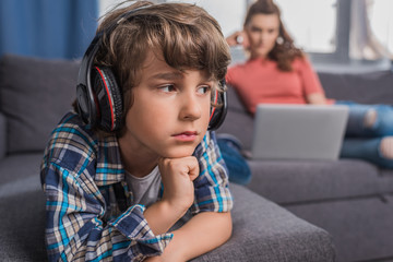 kid listening music in headphones