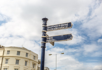 Signs showing the way to the center of the city, the market and tourist information office