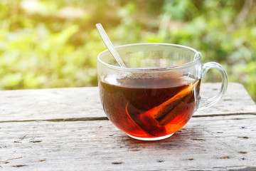 Big cup of black tea with tea bag an metal spoon in it