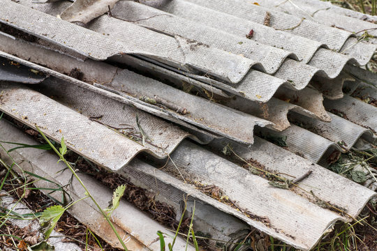 Stacked gray roofing slate broken fragments, closeup shot