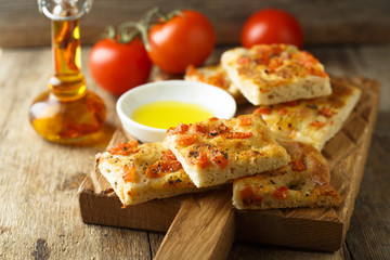 Homemade bread with tomatoes, herbs and olive oil