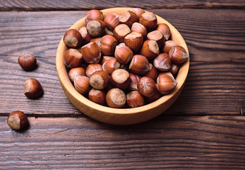 Hazelnuts in a shell in a wooden bowl