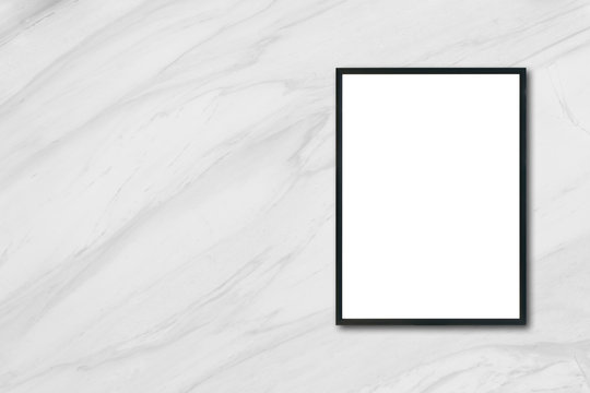 Mock up blank poster picture frame hanging on white marble wall in room - can be used mockup for montage products display and design key visual layout.