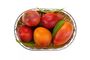 Ripe mango in basket isolated white background, top view