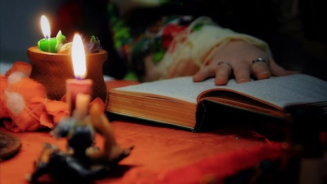 Divination, witch reading spell to luck, magic candles lightning at home