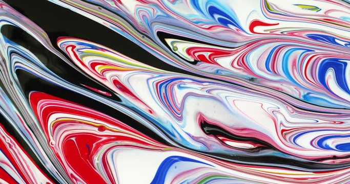 Wet colorful poster paint brushed into an abstract design then blended with blowing air.