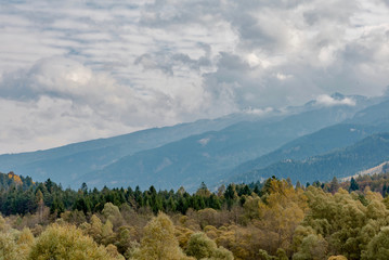 Autumn in the mountains. Funes Valley with snowy landscapes and colorful forests