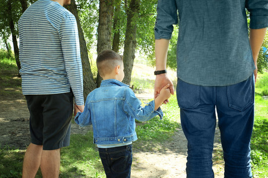 Gay couple with son in park
