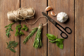 Composition with fresh herbs on wooden background