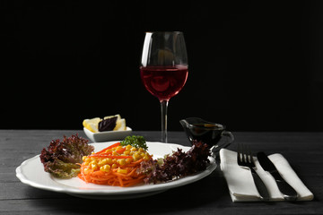 Delicious spicy carrot spaghetti with corn on table