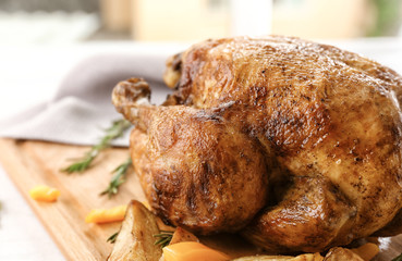 Tasty whole roasted turkey with rosemary on table