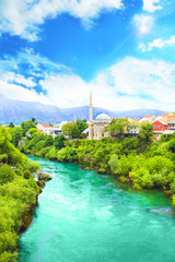 Fototapeta premium Beautiful view of the Karadjozbegov mosque jamia on the banks of the Neretva River in Mostar, Bosnia and Herzegovina
