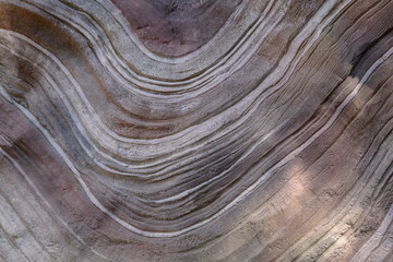 Background texture of wavy curvy lines on a huge stone