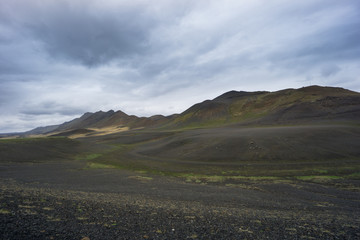 Fototapeta na wymiar Iceland - Scraggy lava mountain chain and some green moss