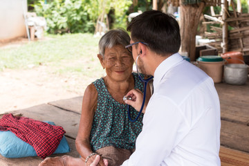 The doctor is examining the patient in the countryside.