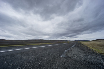 Iceland - Dark road with no end through lava fields