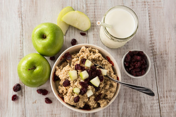 Oatmeal Breakfast Cereal With Milk Apples and Cranberries