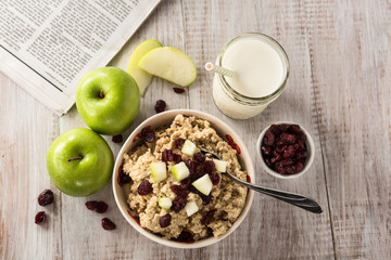 Breakfast Cereal Oatmeal With Fruit and Milk and Newspaper