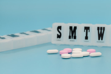 Daily Pill Box table on blue background