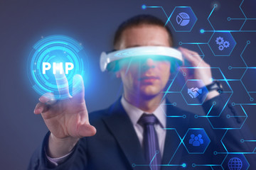 Business, Technology, Internet and network concept. Young businessman working on a virtual screen of the future and sees the inscription: PHP