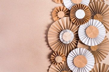 Craft paper flower rosettes on brown background