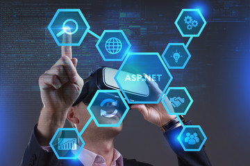 Business, Technology, Internet and network concept. Young businessman working on a virtual screen of the future and sees the inscription: ASP.NET