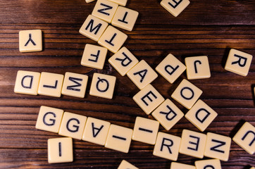 Different random letters on wooden table