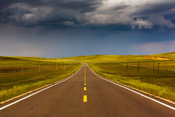 Highway passes through grasslands in Mongolia