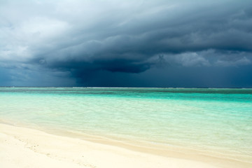 Fototapeta na wymiar Cloudy landscape of Indian ocean sandy beach before the storm