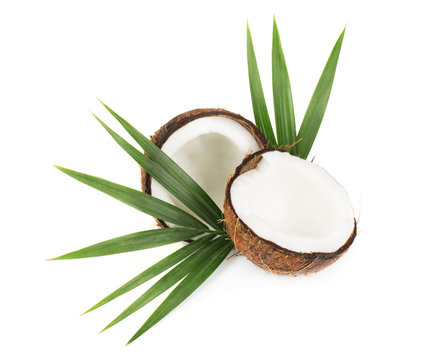 Coconut with half and leaves on white background