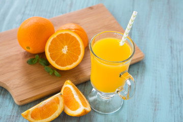 Fresh Orange Juice With Oranges On Wood Board