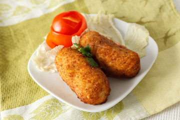 Beef cutlets with greens and vegetables on the plate