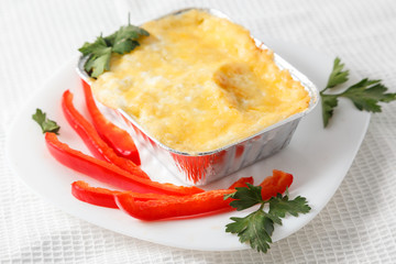 Potato gratin on the foil case box dish