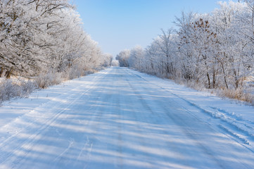 Winter landscape with slippery country road in Dnepropetrovskaya oblast, Ukraine