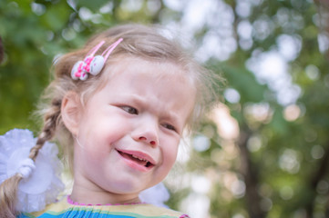 close up of a baby's tearful face