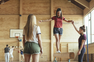 Girls Training Gymnastics at School Gym