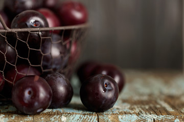 Ripe plums on a dark background. Macro photo.